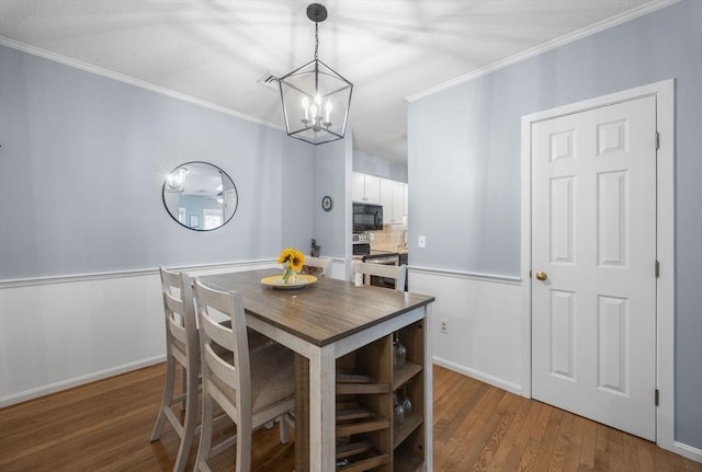44 Bay Farm Rd Unit 44, Duxbury, MA 02332 - dining room featuring a chandelier, wood finished floors, ornamental molding, and baseboards