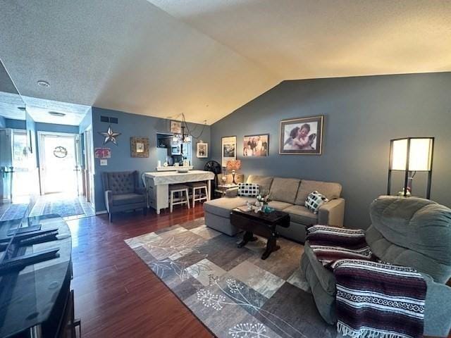 living room with dark wood-type flooring and vaulted ceiling