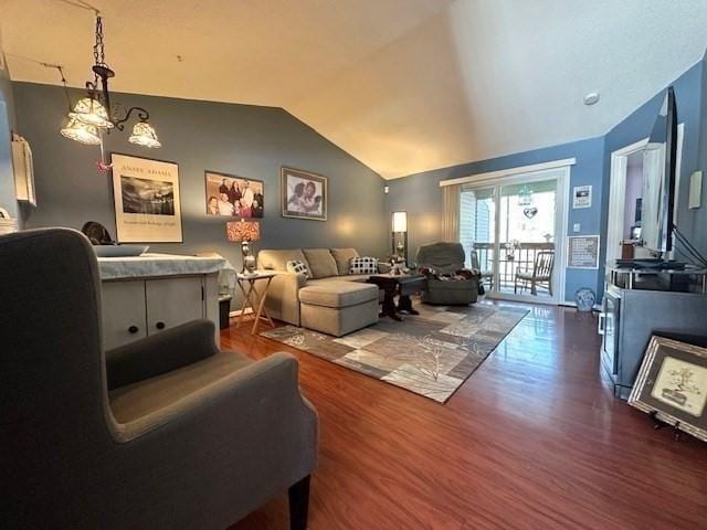 living room featuring vaulted ceiling, dark wood-type flooring, and a notable chandelier