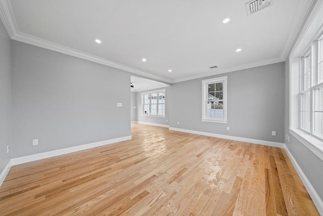 empty room featuring crown molding and light hardwood / wood-style flooring