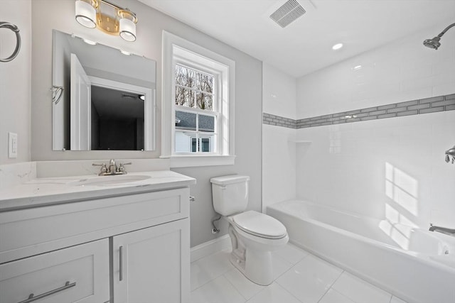 full bathroom with tile patterned floors, vanity, toilet, and tiled shower / bath combo