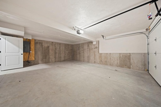 garage featuring electric panel and a garage door opener