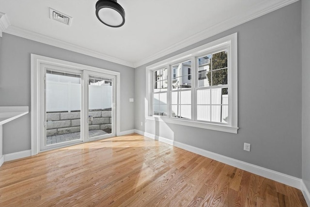 unfurnished room with crown molding and light hardwood / wood-style floors