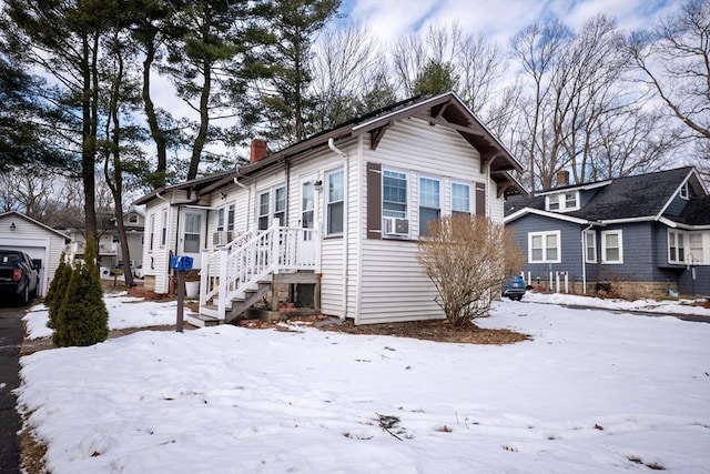 view of front of property featuring a garage and cooling unit