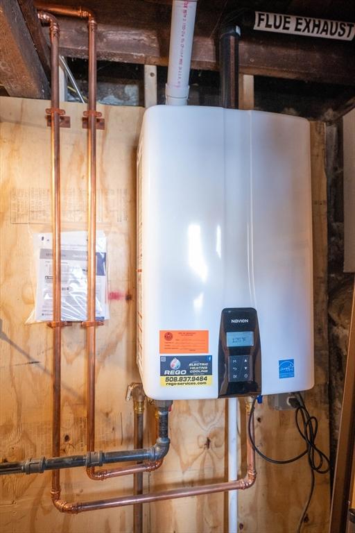 utility room featuring water heater