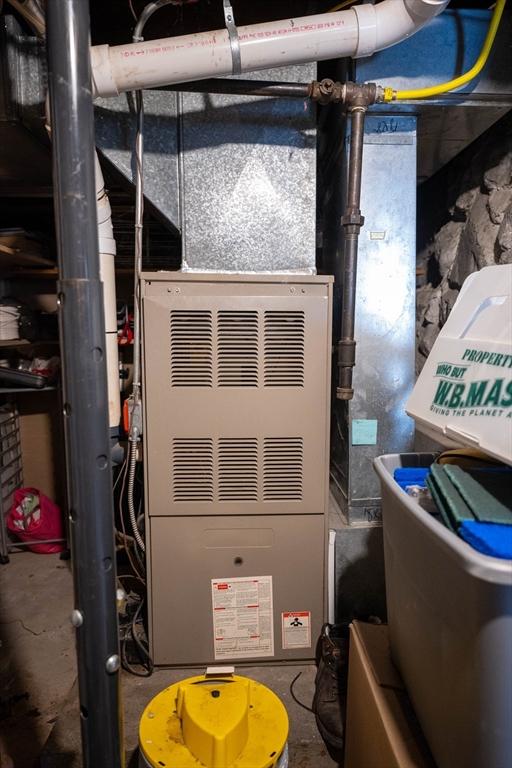 utility room featuring heating unit