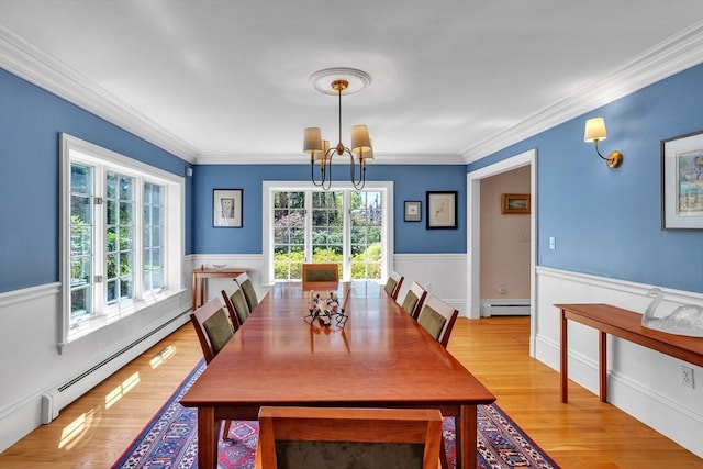12 Old Meadow Rd, Dover, MA 02030 - dining area with a chandelier, a baseboard heating unit, wainscoting, crown molding, and light wood finished floors