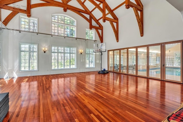 12 Old Meadow Rd, Dover, MA 02030 - unfurnished living room with high vaulted ceiling, wood finished floors, healthy amount of natural light, and beamed ceiling