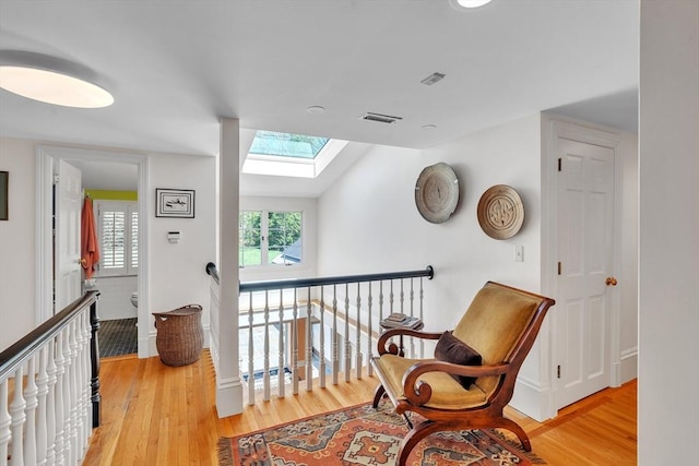 12 Old Meadow Rd, Dover, MA 02030 - sitting room with a skylight, light wood-type flooring, and an upstairs landing