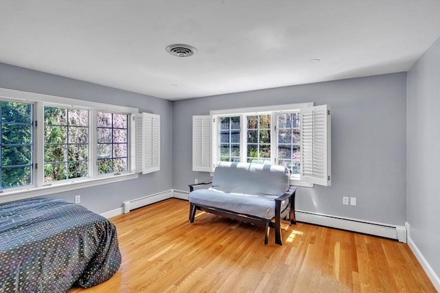 12 Old Meadow Rd, Dover, MA 02030 - bedroom with a baseboard heating unit, baseboards, wood finished floors, and baseboard heating