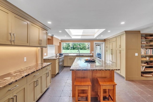12 Old Meadow Rd, Dover, MA 02030 - kitchen with a skylight, a sink, a kitchen island, light stone counters, and ornamental molding