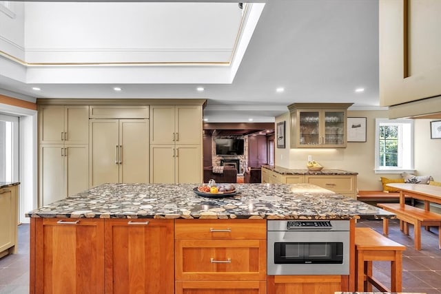 12 Old Meadow Rd, Dover, MA 02030 - kitchen featuring dark stone countertops, recessed lighting, glass insert cabinets, a kitchen island, and tile patterned flooring