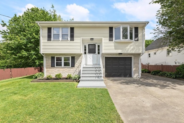 24 Roosevelt St, Taunton, MA 02780 - raised ranch featuring an attached garage, driveway, and stone siding