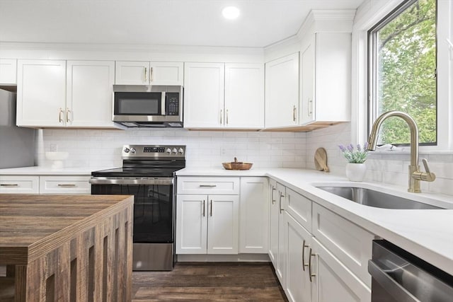 24 Roosevelt St, Taunton, MA 02780 - kitchen with stainless steel appliances, a sink, white cabinetry, light countertops, and dark wood-type flooring