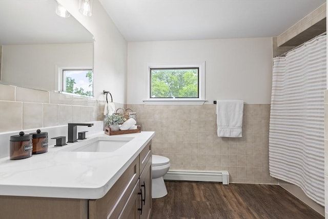 24 Roosevelt St, Taunton, MA 02780 - bathroom featuring a baseboard heating unit, tile walls, plenty of natural light, vanity, and toilet