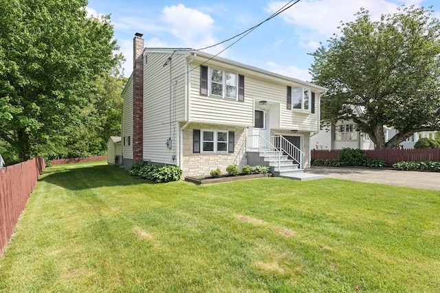 24 Roosevelt St, Taunton, MA 02780 - bi-level home featuring a chimney, driveway, stone siding, and a garage