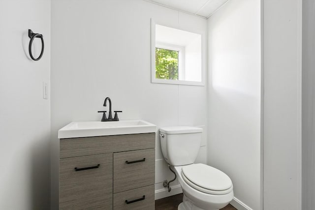 24 Roosevelt St, Taunton, MA 02780 - half bathroom with vanity, toilet, baseboards, and wood finished floors