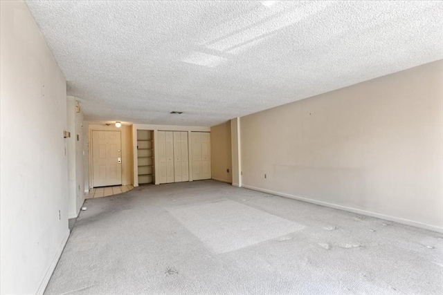 30 Revere Beach Pkwy Unit 207, Medford, MA 02155 - unfurnished bedroom with light colored carpet, a textured ceiling, and baseboards