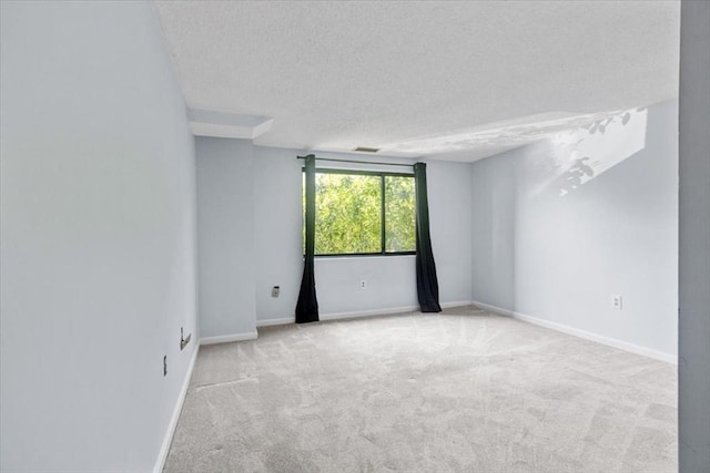 30 Revere Beach Pkwy Unit 207, Medford, MA 02155 - unfurnished room featuring carpet floors, a textured ceiling, and baseboards