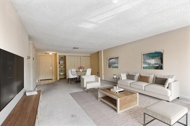 30 Revere Beach Pkwy Unit 207, Medford, MA 02155 - carpeted living area featuring a textured ceiling