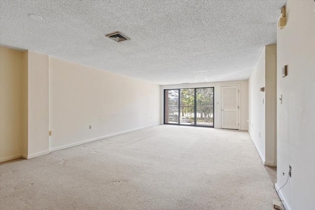 30 Revere Beach Pkwy Unit 207, Medford, MA 02155 - empty room featuring carpet flooring, a textured ceiling, and baseboards