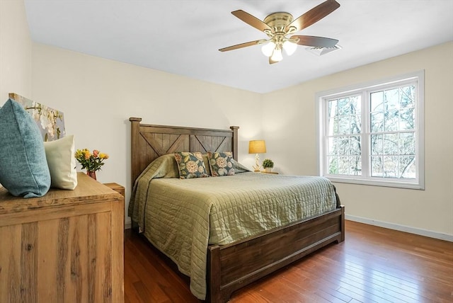 bedroom with visible vents, ceiling fan, baseboards, and hardwood / wood-style flooring