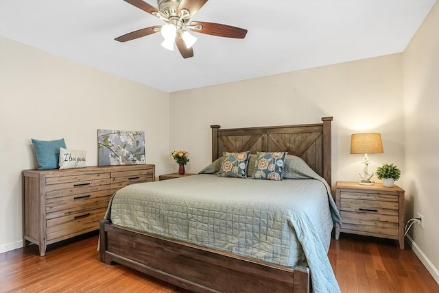 bedroom featuring a ceiling fan, baseboards, and wood finished floors