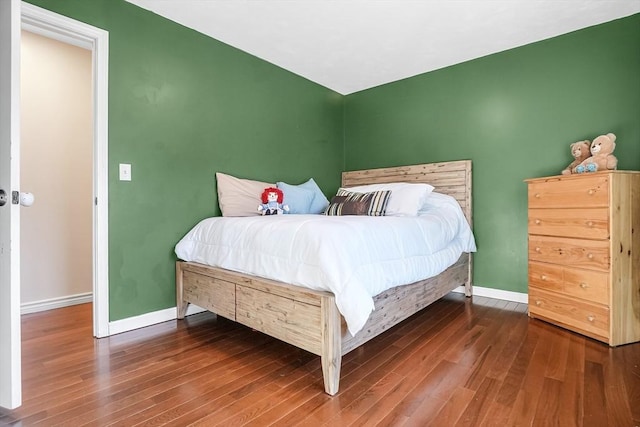 bedroom with wood finished floors and baseboards