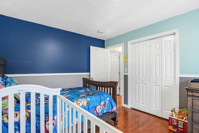 bedroom with a closet and wood finished floors