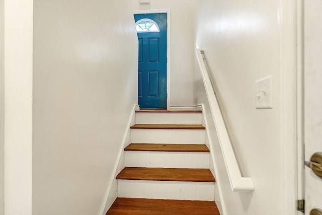 stairs with wood finished floors