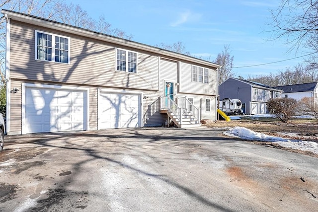 view of front of house featuring a garage and aphalt driveway