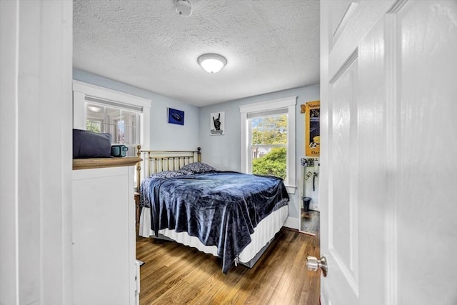 60 Grove St, Barnstable, MA 02601 - bedroom with wood finished floors and a textured ceiling