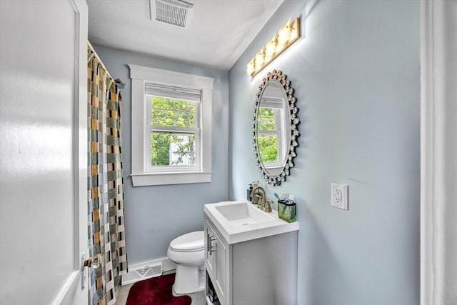 60 Grove St, Barnstable, MA 02601 - bathroom featuring vanity, toilet, baseboards, and curtained shower