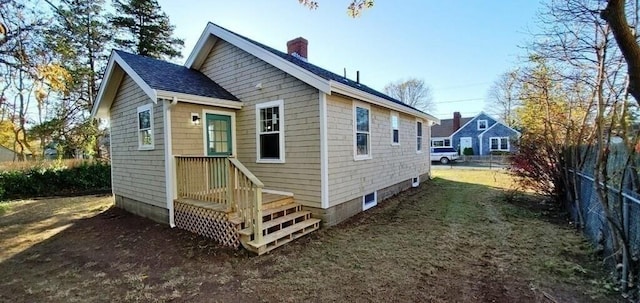 60 Grove St, Barnstable, MA 02601 - view of front of house featuring a chimney and roof with shingles