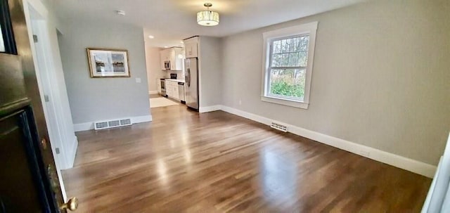 60 Grove St, Barnstable, MA 02601 - unfurnished dining area with dark wood-type flooring and baseboards