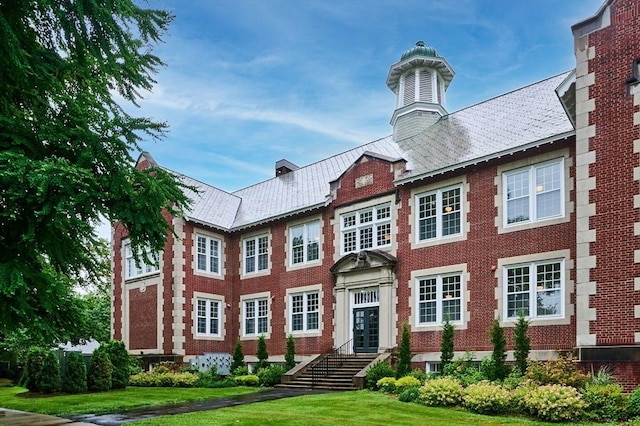 58 Main St Unit 4, Hatfield, MA 01038 - view of front facade with a front yard, brick siding, and french doors