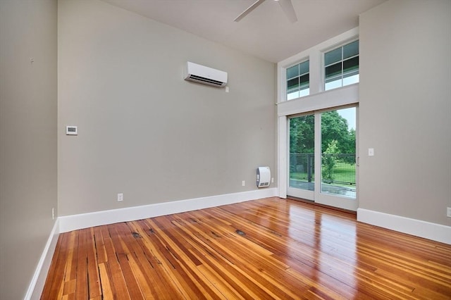 58 Main St Unit 4, Hatfield, MA 01038 - empty room with a wall mounted air conditioner, a ceiling fan, and hardwood / wood-style floors