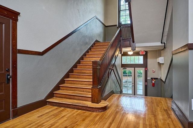 58 Main St Unit 4, Hatfield, MA 01038 - stairs with a high ceiling, plenty of natural light, french doors, wood-type flooring, and a textured wall