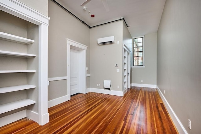 58 Main St Unit 4, Hatfield, MA 01038 - unfurnished living room featuring hardwood / wood-style flooring, an AC wall unit, and built in shelves