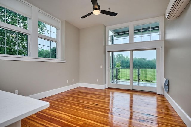 58 Main St Unit 4, Hatfield, MA 01038 - spare room with a wall unit AC, wood finished floors, and ceiling fan
