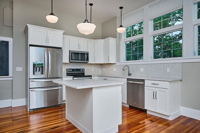 58 Main St Unit 4, Hatfield, MA 01038 - kitchen with appliances with stainless steel finishes, tasteful backsplash, and dark wood-type flooring