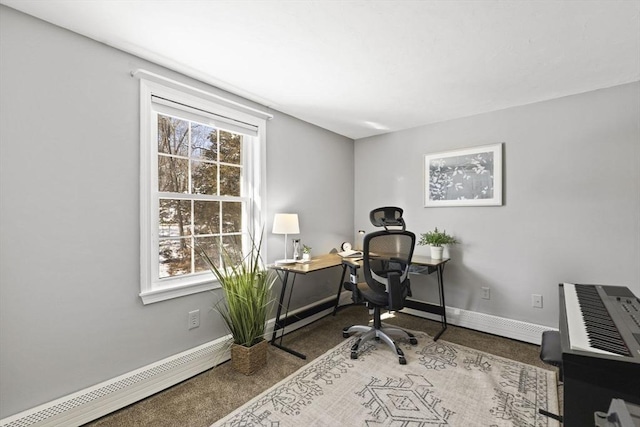 carpeted office space with a baseboard heating unit