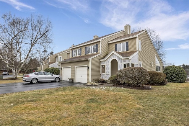 view of front of home featuring a garage and a front yard