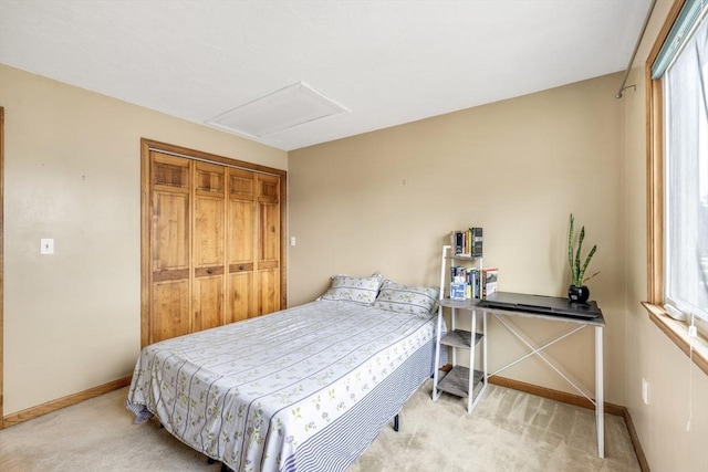 bedroom with light carpet and a closet