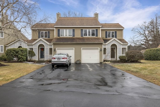 view of front of property featuring a front lawn and a garage