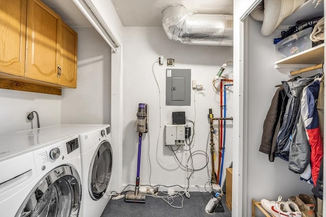 laundry area with washer and clothes dryer, cabinets, and electric panel