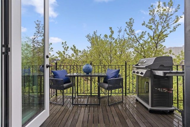 wooden deck featuring a grill