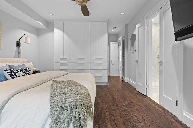 bedroom with dark wood-style floors, recessed lighting, ceiling fan, baseboards, and connected bathroom