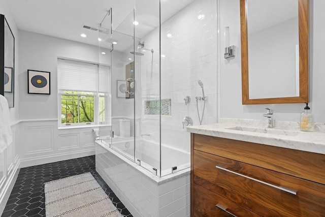 bathroom featuring vanity, wainscoting, recessed lighting, and tile patterned flooring