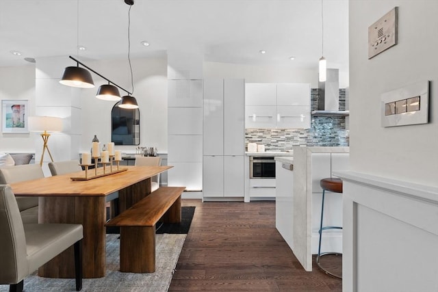 dining room with dark wood-style flooring and recessed lighting